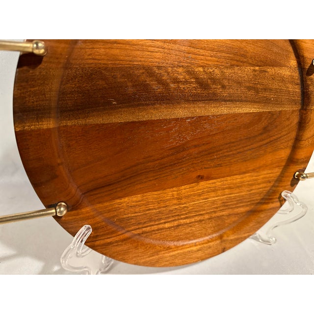 A Mid-Century American walnut serving tray with brass tone hardware and walnut handles. 16”l x 12”w x 1.5” h.