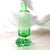 This is a slender, bright green, decanter with a clear base with a bubble in it. It comes with a matching green stopper...
