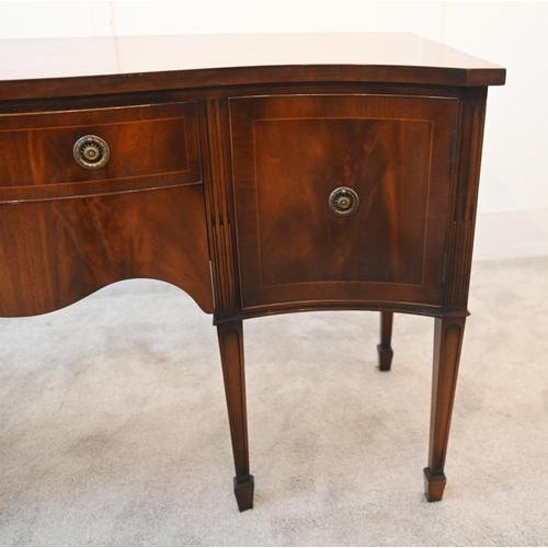 A handsome mahogany serpentine front sideboard in the Sheraton style, dating to the late 19th century, circa 1890 The...