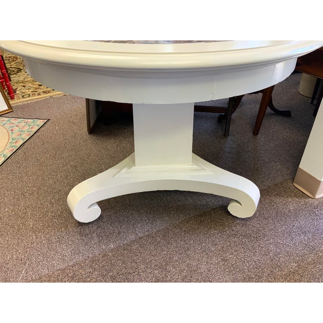 Neo classical style table with replaced marble top section. Pedestal base on casters. Has been painted.