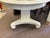 Neo classical style table with replaced marble top section. Pedestal base on casters. Has been painted.