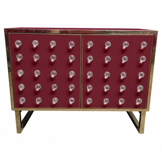 Burgundy cabinetry gives this Italian dry bar a rich, contemporary backdrop for forty clear Murano glass spheres. The...