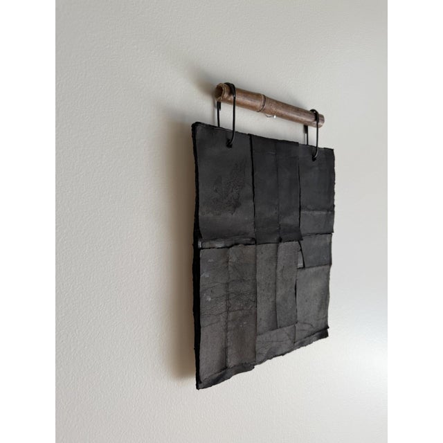 A sculptural mixed media wall work by Italian artist Silvia De Marchi, Nero su Nero 05 explores depth, restraint, and...