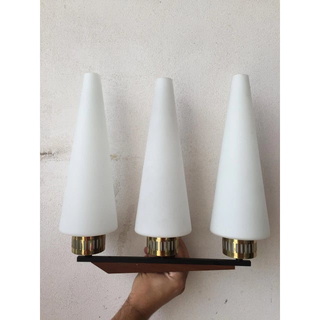 - Beautiful appliques in conical opaline glass - Brass details - Metal profile and base in teak - Each applique features...