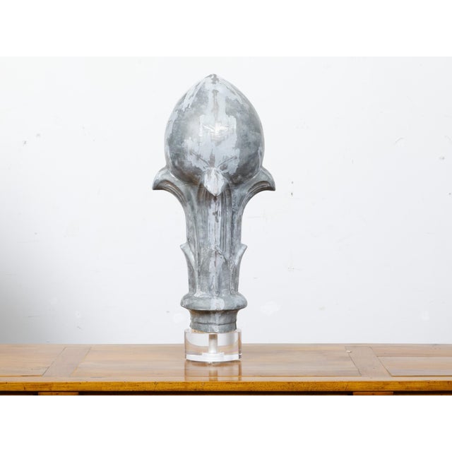 A French zinc crowned acorn architectural fragment from the 19th century mounted on a custom lucite base. This French zinc...