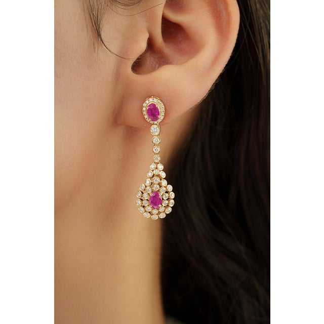 These elegant chandelier drop earrings feature 1.71 carats of natural rubies set in 14K Yellow gold. The ruby measuring...