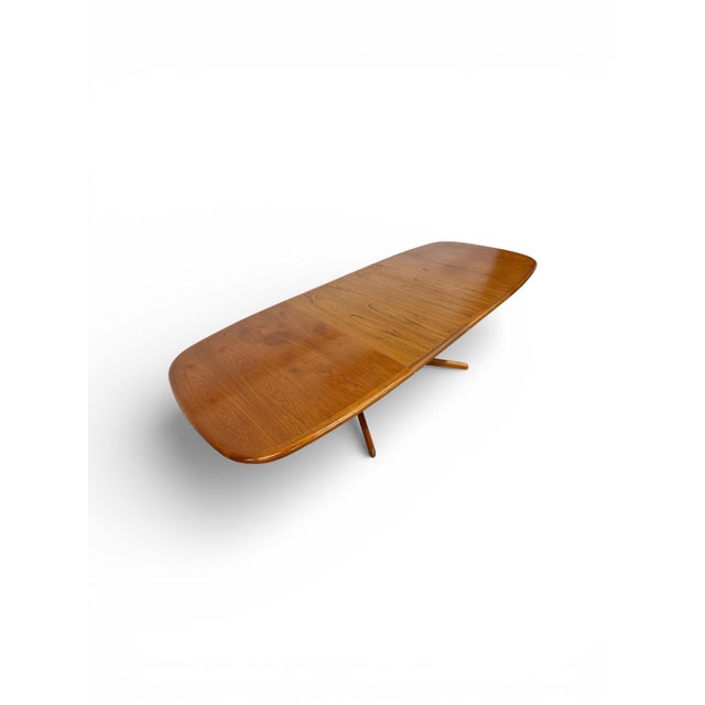 This stunning vintage 1970s Danish Modern teak dining table is a true statement of Scandinavian craftsmanship and timeless...