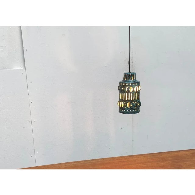 Rare pendant lamp made of ceramic. A functional light and at the same time an imposing object. The cylindrical screen...