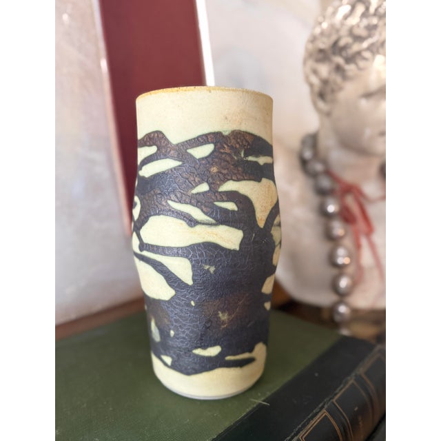 Striking vintage studio pottery vase featuring an abstract slip-decorated design in deep brown over a warm cream stoneware...