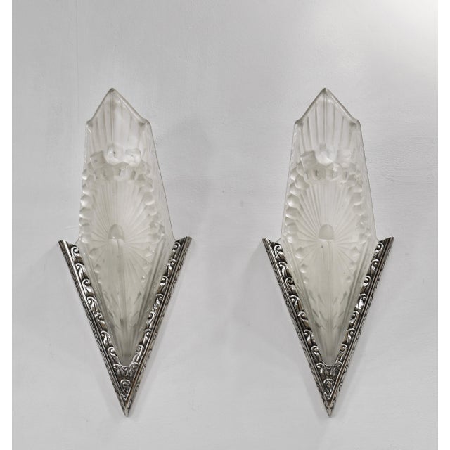 Charles Schneider A wonderful pair of French art deco wall sconces made around 1930. The solid brass mounts hold beautiful...