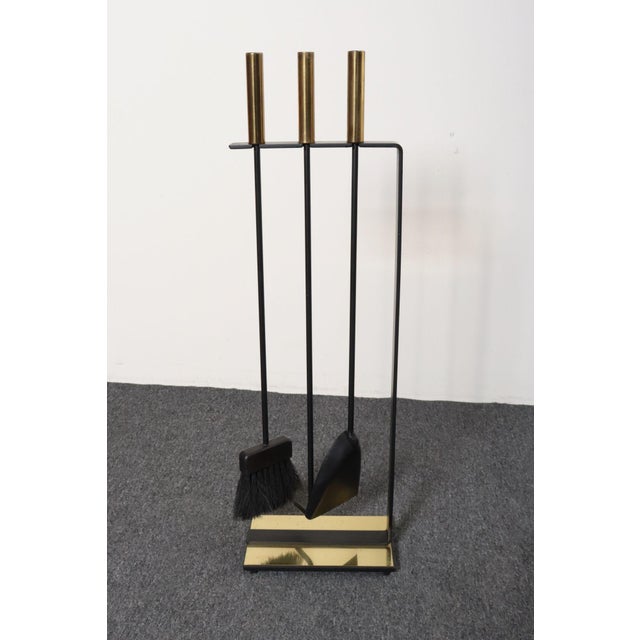 Stylish, modernist iron fireplace tool set with brass handles and base trim (ca. 1960s, USA). Includes the rectangular...