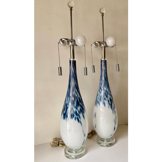These striking Large Scale contemporary-style Lamps feature a hand-blown white glass body detailed with a distinct,...