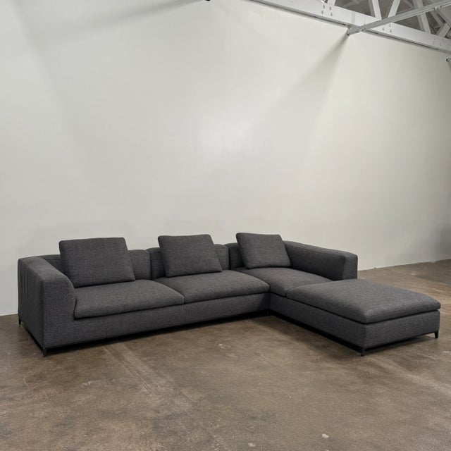 The B&B Italia Michele Club Sectional Sofa blends traditional elegance with a more contemporary design, featuring a grey...