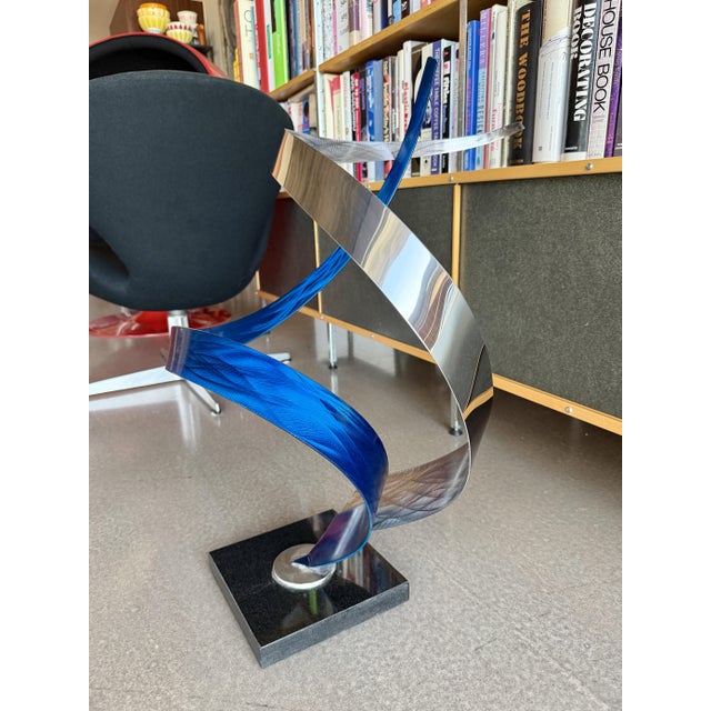Incredible large scale intertwined metal ribbon sculpture. High polish, reflective chrome and blue curved aluminum pieces...