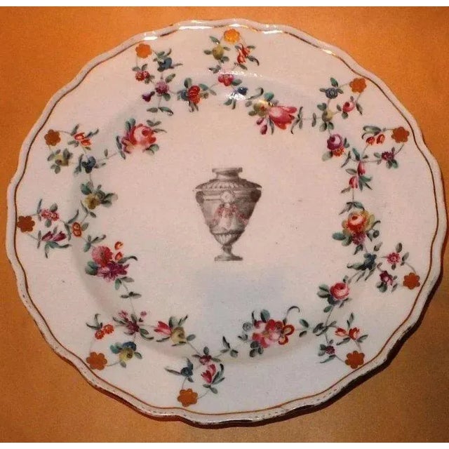 Antique 18th c. Chelsea Derby porcelain plate. Hand painted with a central urn and a border of floral garlands enriched by...