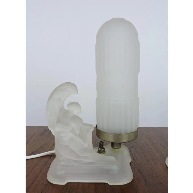 Beautiful pair of Art Deco boudoir table lamps with frosted glass nudes holding lyres attributed to McKee Glass Company of...