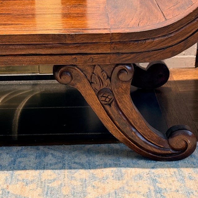 Indonesian Bench A backless low bench designed with scrolled arms and detailed leg carvings. Chiefly for decorative use....