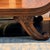 Indonesian Bench A backless low bench designed with scrolled arms and detailed leg carvings. Chiefly for decorative use....
