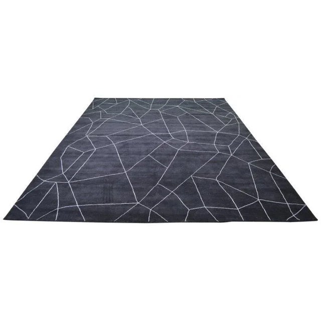 Moroccan hand knotted wool rug with abstract design.