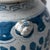 Early 21st Century Pair of Chinese Blue and White Glazed Jars With Foo Dog Finials For Sale - Image 5 of 10