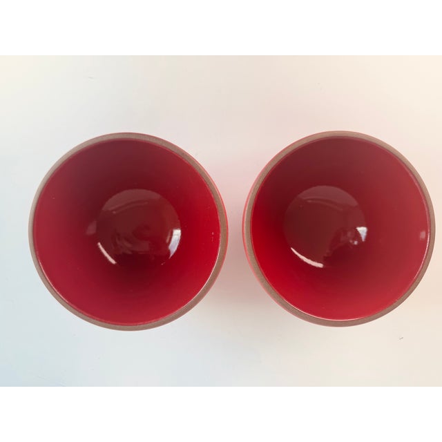 A beautiful pair of bowls in the tomato red glaze from Heath Ceramics. The exterior is a matte glaze and the interior of...