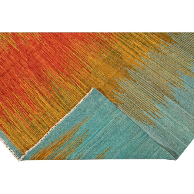 Beautiful modern Kilim flat-weave wool rug. This Kilim rug full of art has an orange, yellow, and blue field in a gorgeous...