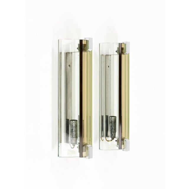 Midcentury beautiful pair or sconces in glass (green and bronze) and steel by Veca. Made in Italy in the 1970s. The...