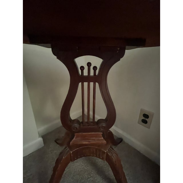 Infuse classical elegance into your living space with this beautiful mid-century mahogany side table by renowned American...