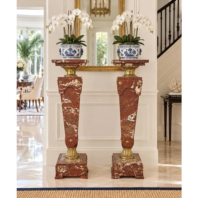 impressive pair of tall French architectural pedestals or plant stands crafted in richly veined red and cream marble with...
