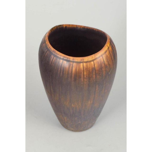 Gunnar Nylund for Rörstrand Vase, mid-20th century. Tall, organically shaped stoneware vase with a rich brown running...
