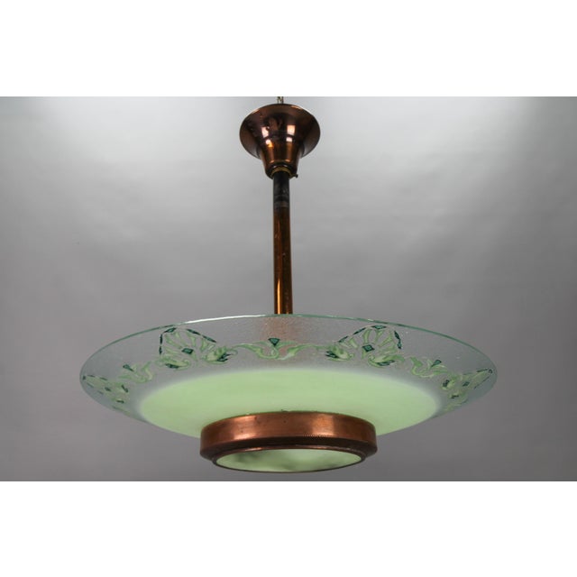 French Art Deco green glass and copper pendant chandelier by Loys Lucha from circa 1930s. This beautiful pendant light...