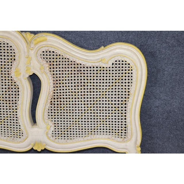An exquisite French Louis XV-style painted and giltwood sideboard, distinguished by its graceful serpentine silhouette,...