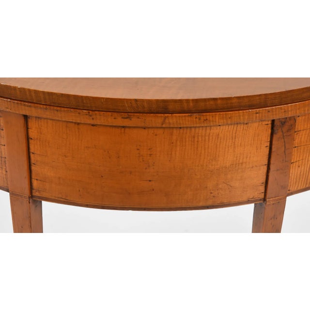 Beautiful in its simplicity, American Federal Tiger Maple Demilune Card table, Early 19th Century. A fold top with...