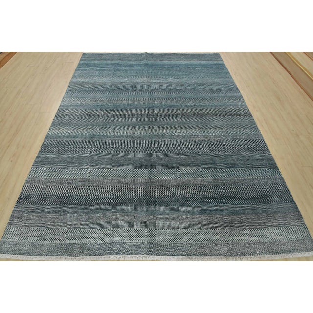 This fine contemporary area rug is hand-knotted with an all-wool pile on a cotton foundation. This rug is new and in...