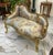 This elegant French Rococo-style settee features a beautiful sky blue and neutral floral-patterned upholstery complemented...