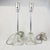 Pair of vintage glass candlestick lamps featuring a sleek, tall profile with elegant etched detailing on the central glass...