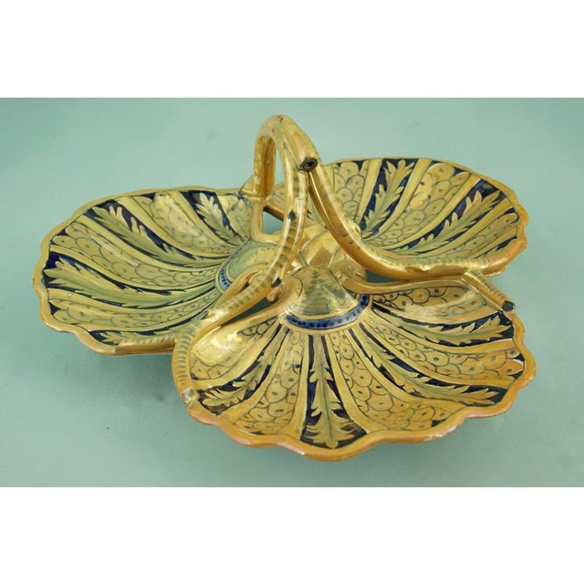 An Italian delightful centerpiece in glazed and vitrified ceramic, entirely hand-crafted on a lathe, then hand-decorated...