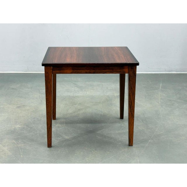 Authentic Danish mid century side table from the 1960s, crafted from solid wood with rich rosewood veneer. Clean geometric...