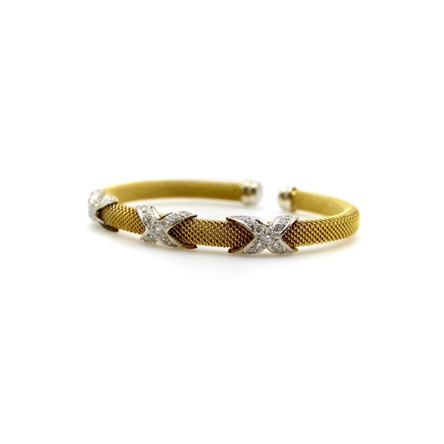 This is a beautifully woven 14k gold bracelet with diamond X details, in a style made popular by Schlumberger and Tiffany...