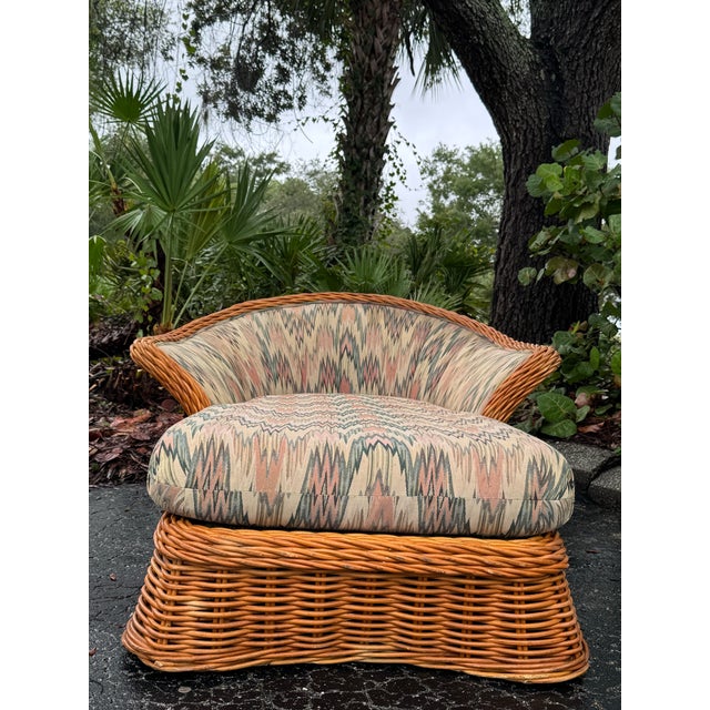 A fabulous vintage rattan chaise lounge with all the sculptural appeal of Palm Springs glamour and relaxed coastal living....