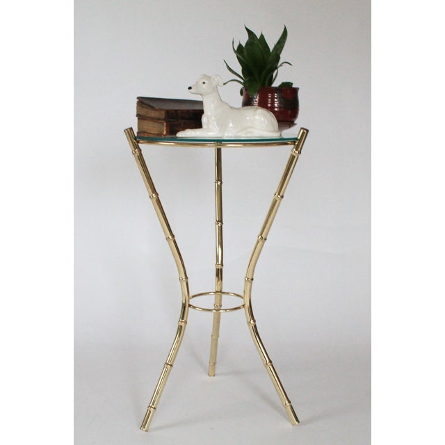 Hollywood Regency style vintage glass top faux bamboo side table in a brass finish. No makers mark. Condition notes, Some...