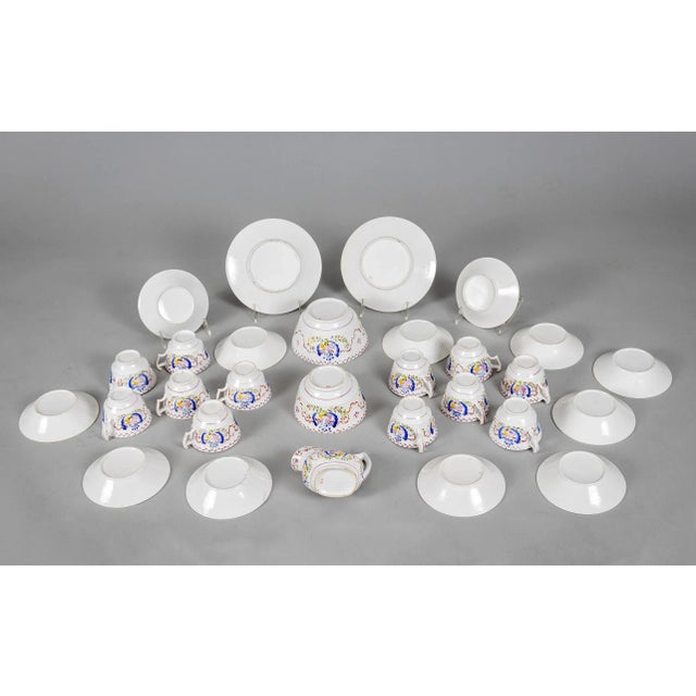 An early Staffordshire pink lusterware partial tea and dessert service consisting of 17 pieces: 12 cups and saucers, 2...