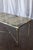 This vintage brass and marble rectangle coffee table pairs an elegantly veined marble top with a refined brass frame,...
