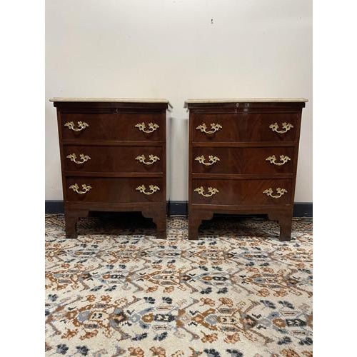 A stunning pair of french style bedside chests, each featuring a graceful form and fine inlaid wood finish. The elegant...