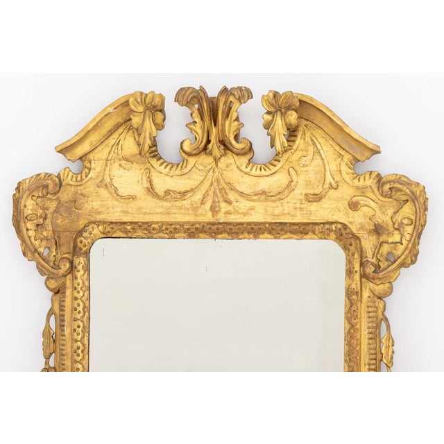 George II Carved Giltwood Framed Mirror, beveled edge, Ashley-Kent label to back hanger. Mirror plate. 35" H x 20.25" W;...