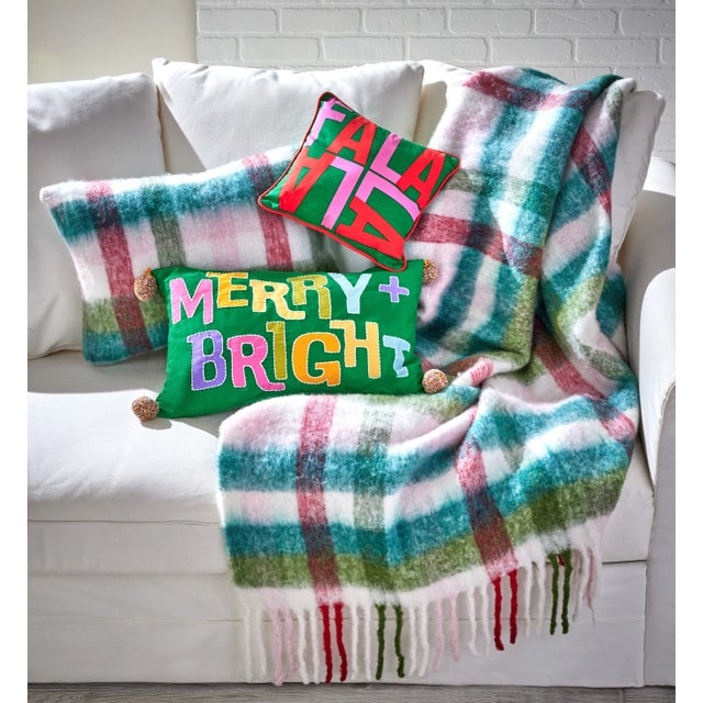The Groovy Plaid Throw With Fringe brings a warm, inviting touch to any space with its soft mohair blend plaid and playful...