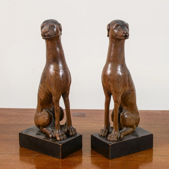 This pair of wooden dog statues captures the stylized elegance typical of the art deco period, dating back to the first...