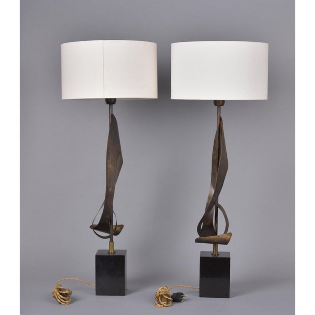 Found in Italy, this pair of brutalist-style table lamps date from the 1970s. Base is black marble or granite with metal...