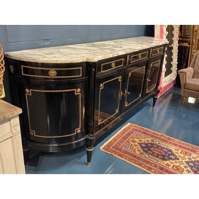 Fine French Louis XVI style black lacquered and brass D-shape sideboard. This is a mid‑20th‑century French Louis XVI–style...