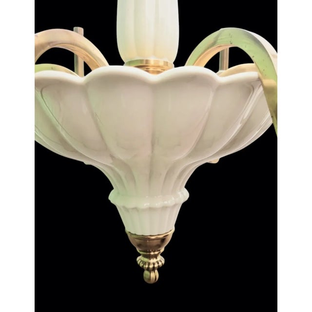 A gorgeous 6 light solid brass and ceramic chandelier by Lenox. The chandelier features 6 candleabra style brass arms with...